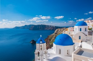 White washed, cubiform houses dot the Santorini's hilltops overlooking the Aegean Sea